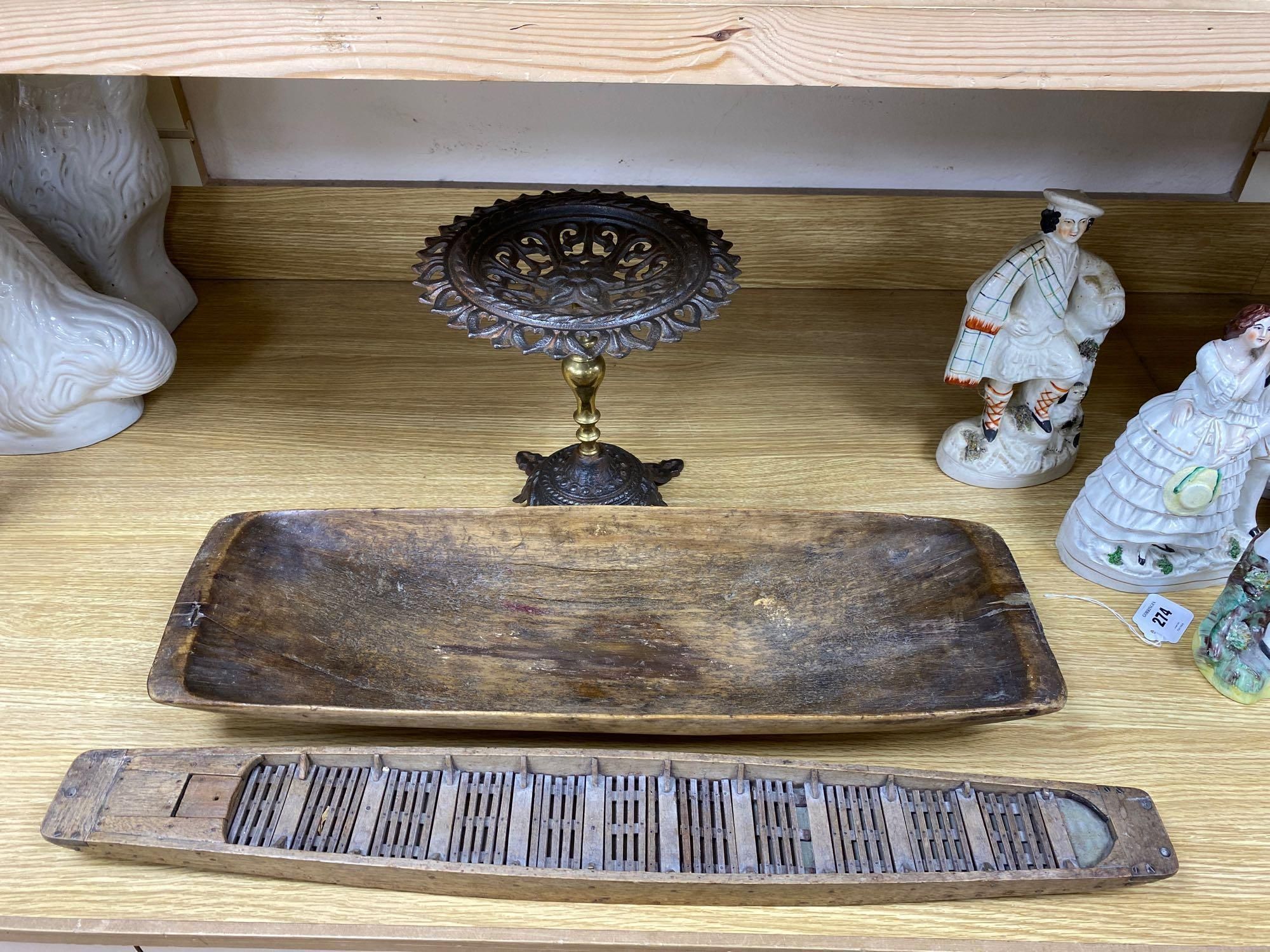 A 19th century primitive beech rectangular dish, carved from the solid, 64cm, a Victorian cast iron pedestal stand, 28cm and a model wo